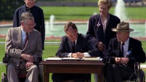 Bush signs into law American Disabilities Act